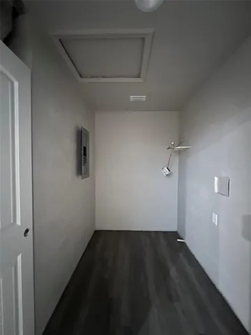 a view of a room with wooden floor and a window