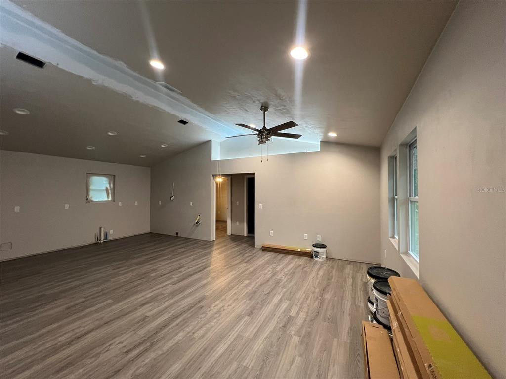 24948 Northwest 187th Avenue High Springs, FL 32643 - Photo 4 of 14 an empty room with wooden floor and windows