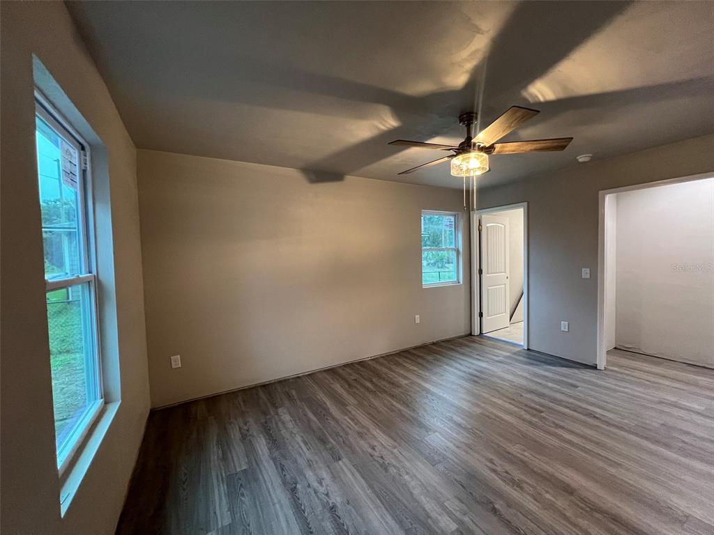 24948 Northwest 187th Avenue High Springs, FL 32643 - Photo 6 of 14 a view of an empty room with window and wooden floor
