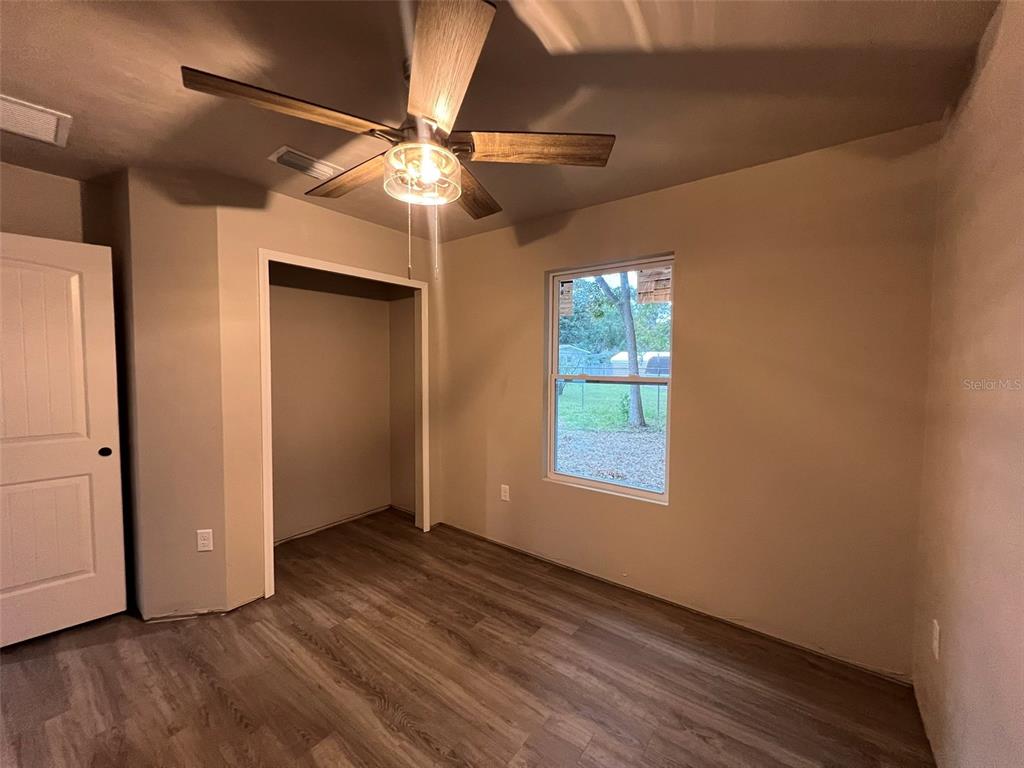 24948 Northwest 187th Avenue High Springs, FL 32643 - Photo 10 of 14 an empty room with wooden floor fan and windows