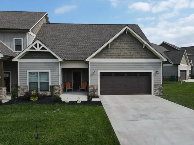 a front view of a house with a garden and yard