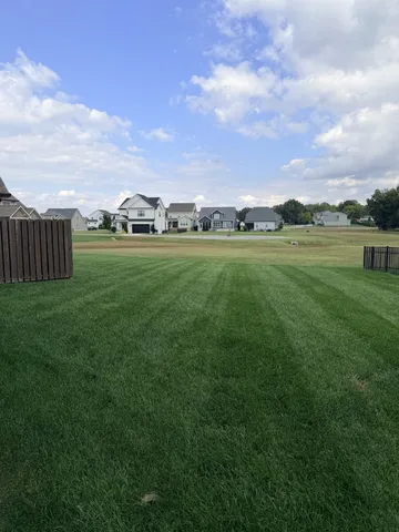 a view of a green field with clear sky
