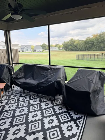 a living room with a table and a fireplace