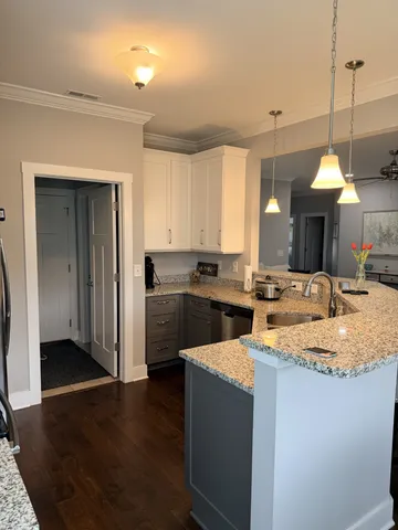 a kitchen with sink cabinets and wooden floor