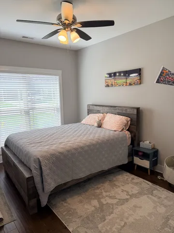 a bedroom with a bed and a chandelier