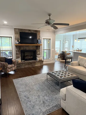 a living room with furniture a fireplace and a flat screen tv