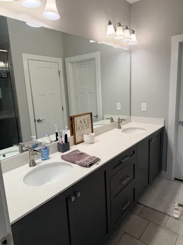 a bathroom with a sink vanity and a mirror