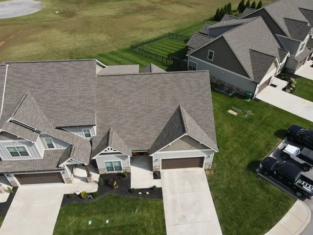 an aerial view of a house with swimming pool and garden