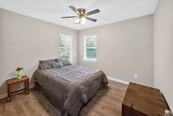 a bedroom with a bed and a chandelier