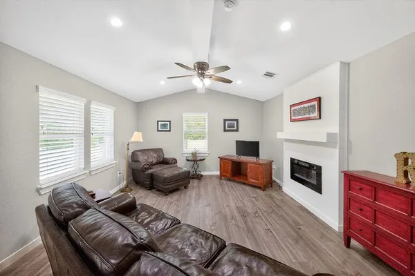 a living room with furniture fireplace and flat screen tv