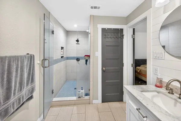 a bathroom with a sink a toilet and shower