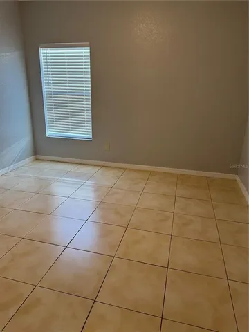 a view of a room with an empty space and a window