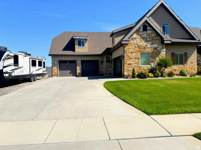 896 West 675 South Mapleton, UT 84664 - Photo 2 of 77 Stucco and stone facade home featuring a two-car garage, dormer window, and established front landscaping