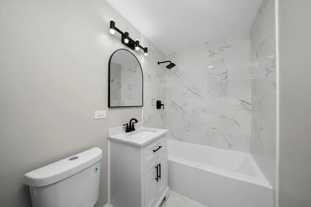 a bathroom with a sink a toilet and a bathtub