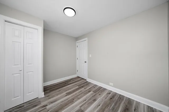 a view of a room with wooden floor