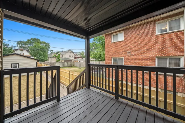 a view of balcony with wooden floor