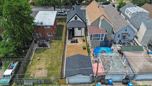 an aerial view of residential house with outdoor space and swimming pool