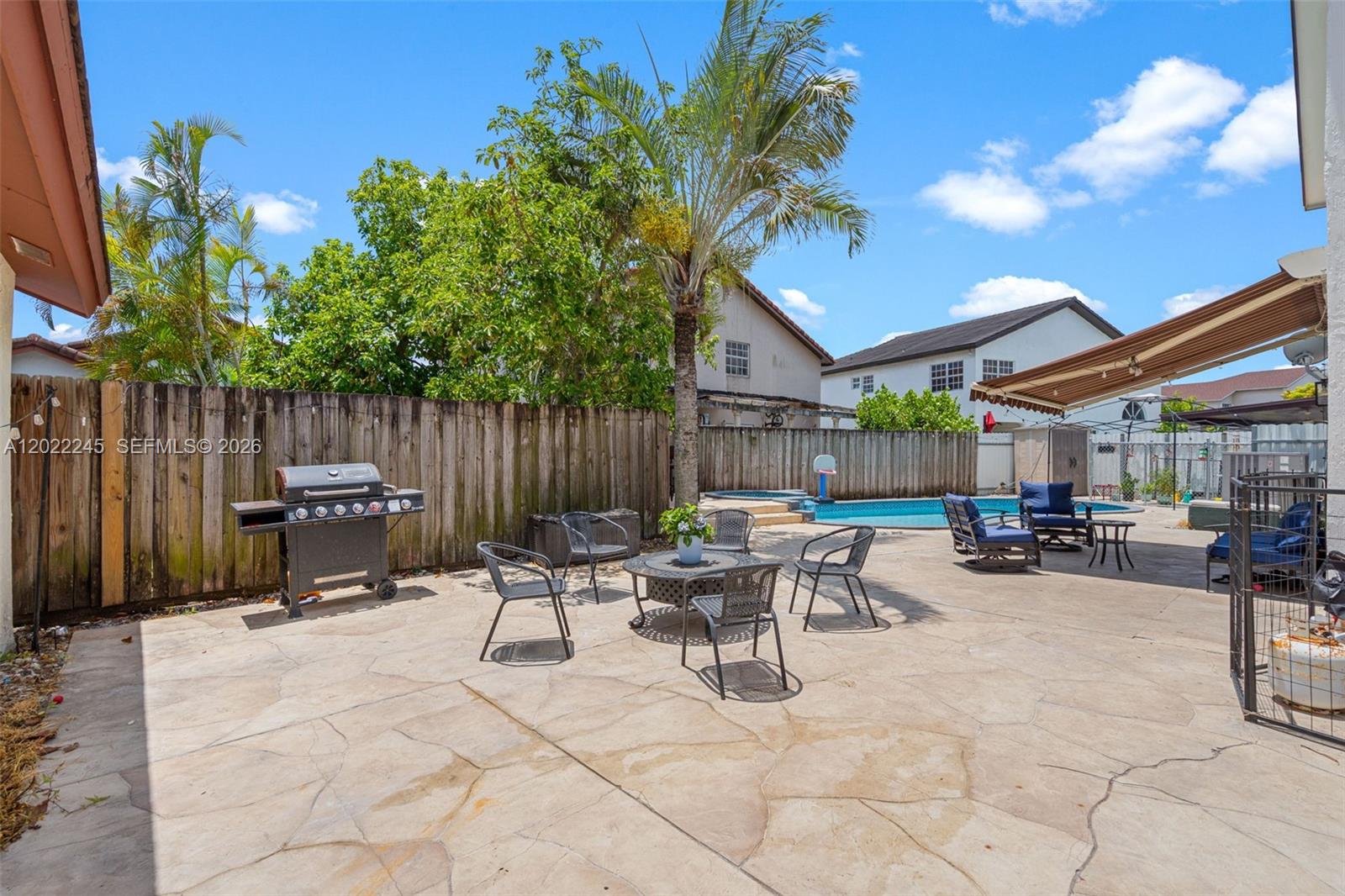 15530 Southwest 59th Street Miami, FL 33193 - Photo 41 of 58 a view of a patio with a table and chairs
