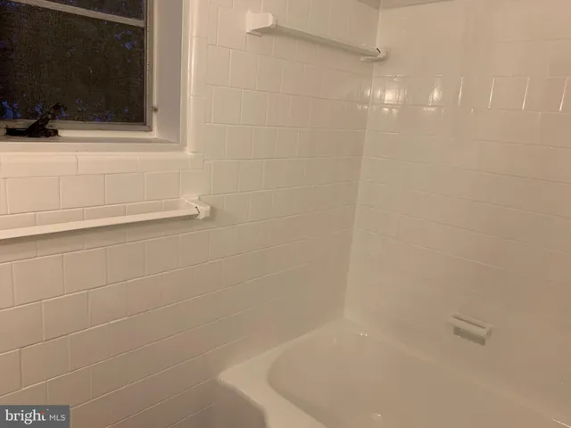 a bathroom with a shower and a bathtub