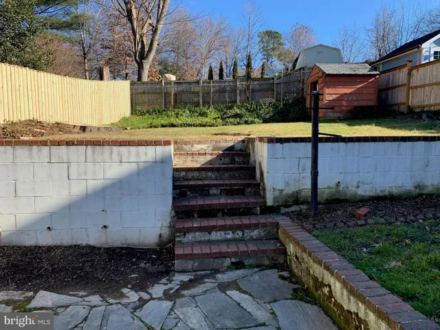 a view of a backyard with pathway and a building