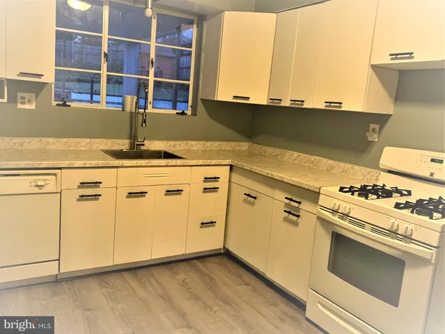 a kitchen with granite countertop a stove and a sink