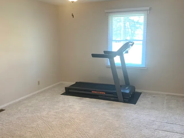 a bed sitting in a bedroom next to a window