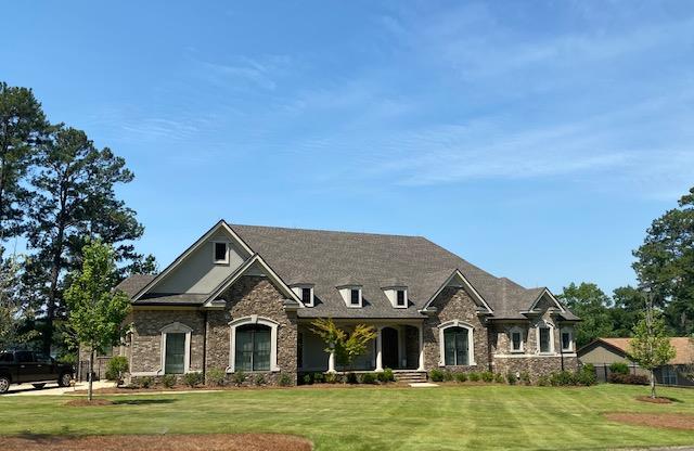 a front view of a house with a garden