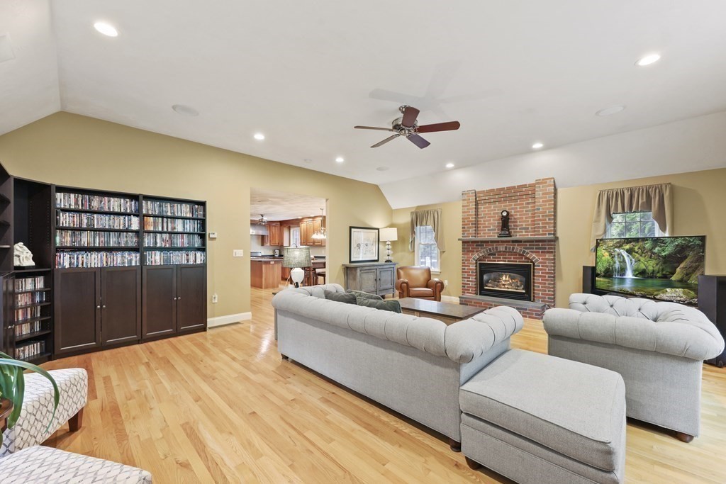 104 Forest Street Middleton, MA 01949 - Photo 16 of 41 a living room with furniture a fireplace and a flat screen tv