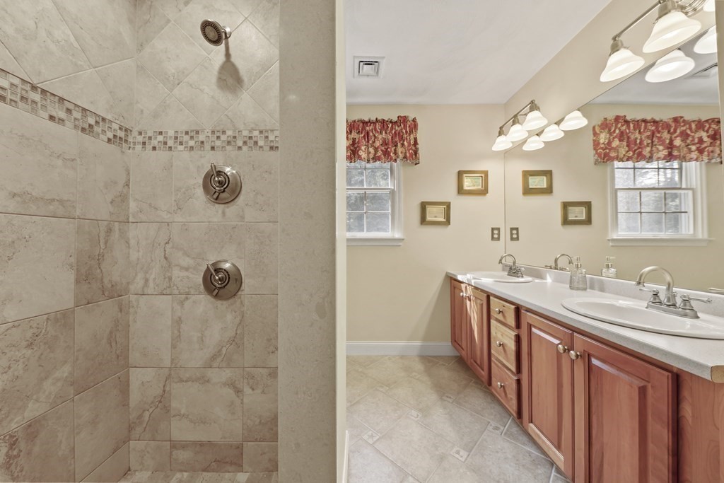 104 Forest Street Middleton, MA 01949 - Photo 22 of 41 a bathroom with a double vanity sink mirror and shower