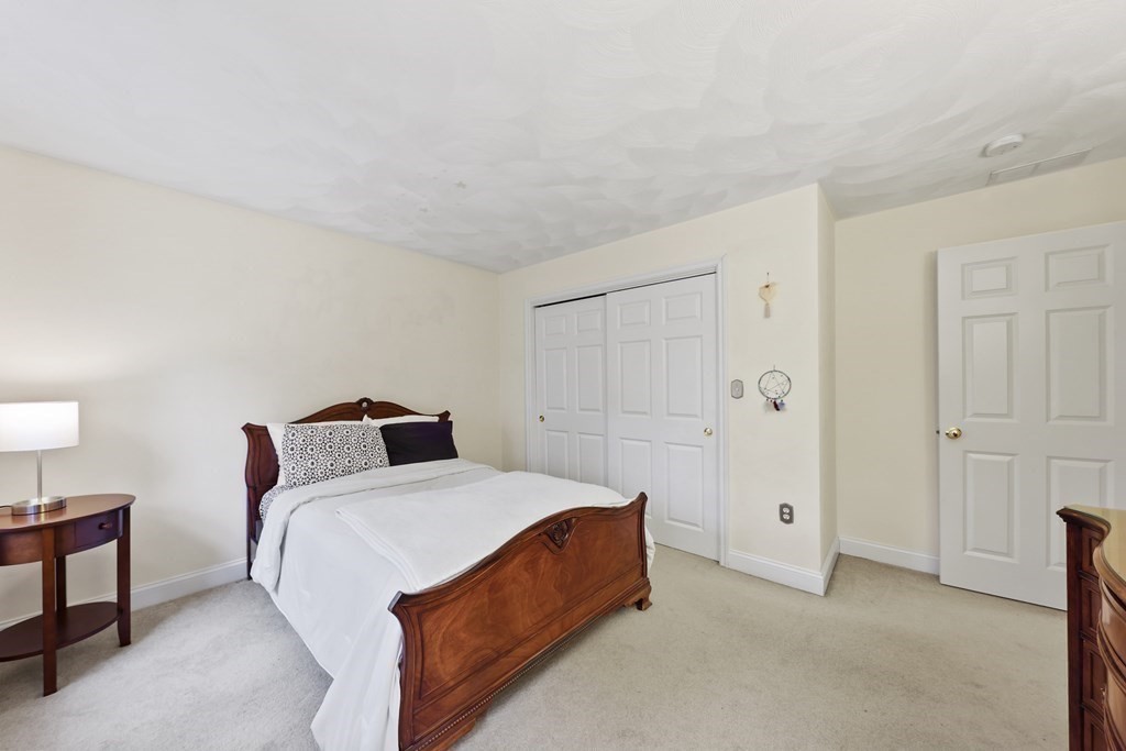 104 Forest Street Middleton, MA 01949 - Photo 24 of 41 a bedroom with a bed and a lamp