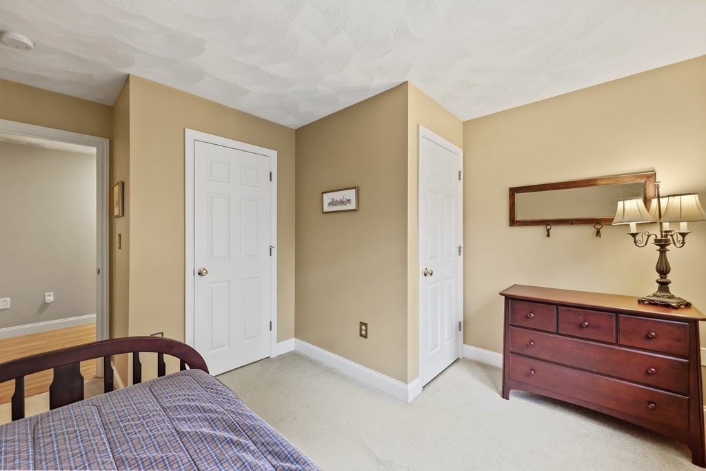 104 Forest Street Middleton, MA 01949 - Photo 27 of 41 a bedroom with a bed and a dresser