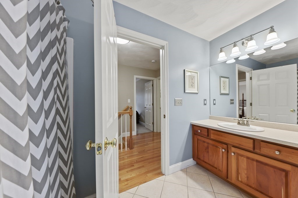 104 Forest Street Middleton, MA 01949 - Photo 28 of 41 a spacious bathroom with a granite countertop sink mirror and double