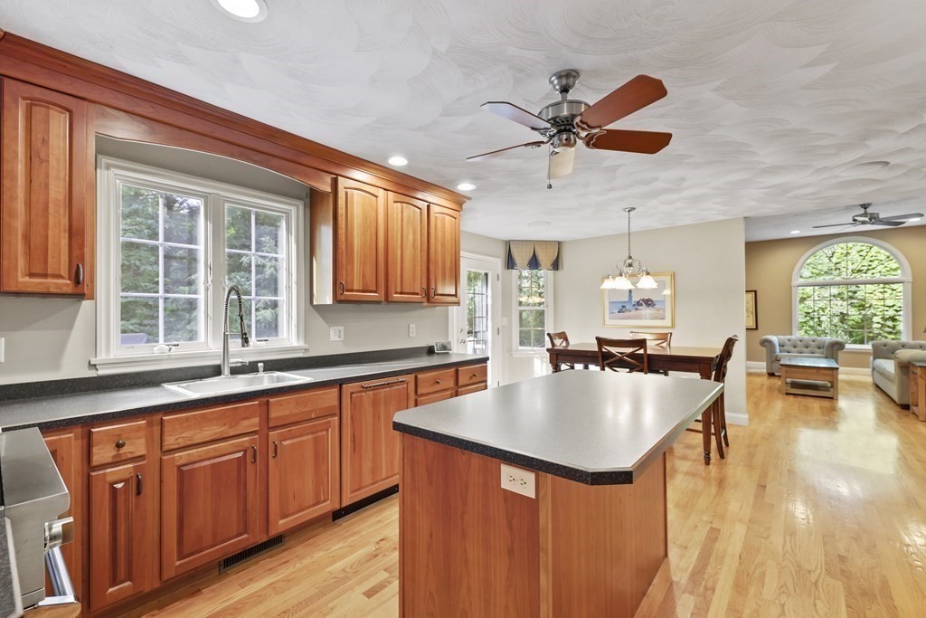 104 Forest Street Middleton, MA 01949 - Photo 6 of 41 a large kitchen with kitchen island a large counter space a sink a window and living room view