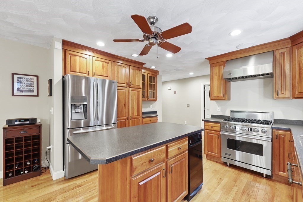 104 Forest Street Middleton, MA 01949 - Photo 8 of 41 a kitchen with stainless steel appliances granite countertop a stove a sink and a refrigerator