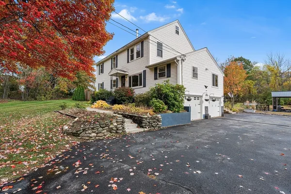 a view of a white house with a yard