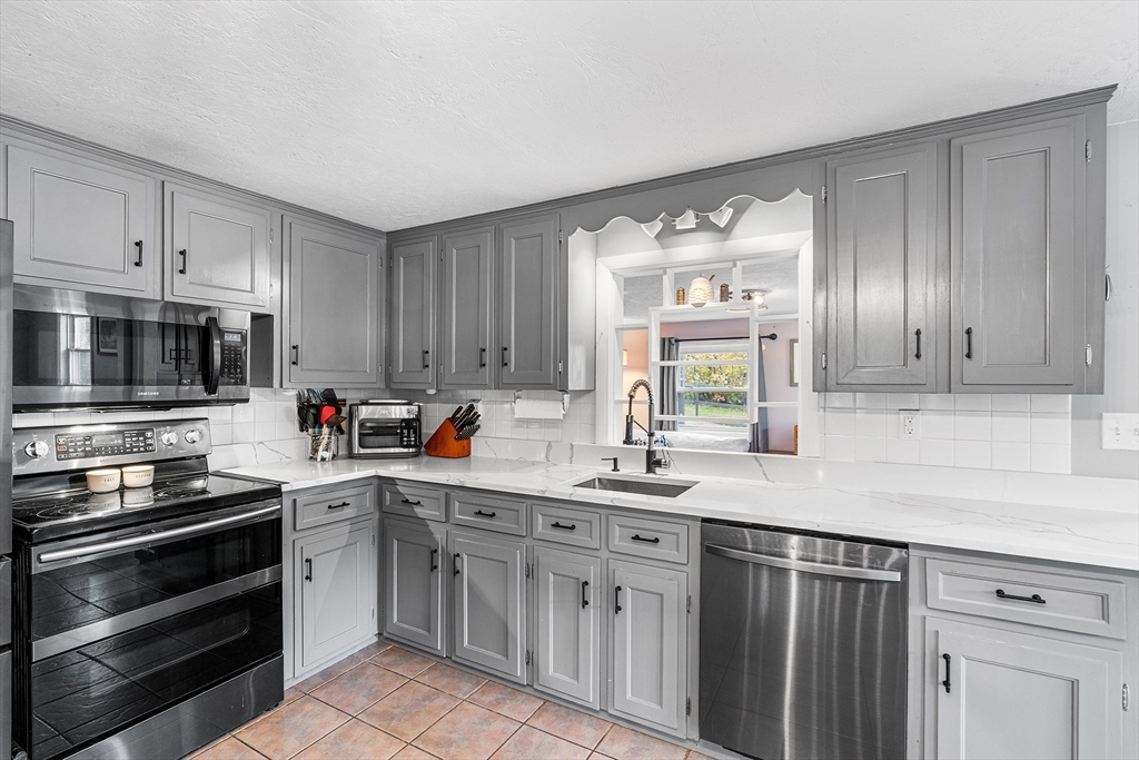 73 North Common Road Westminster, MA 01473 - Photo 4 of 41 a kitchen with stainless steel appliances a sink stove and cabinets