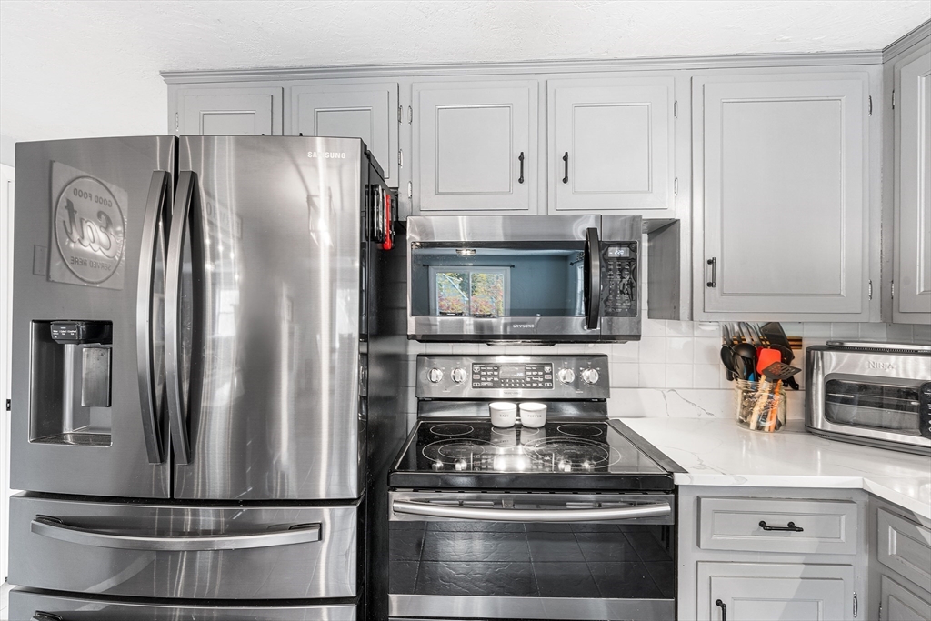 73 North Common Road Westminster, MA 01473 - Photo 5 of 41 a metallic refrigerator freezer sitting in a kitchen