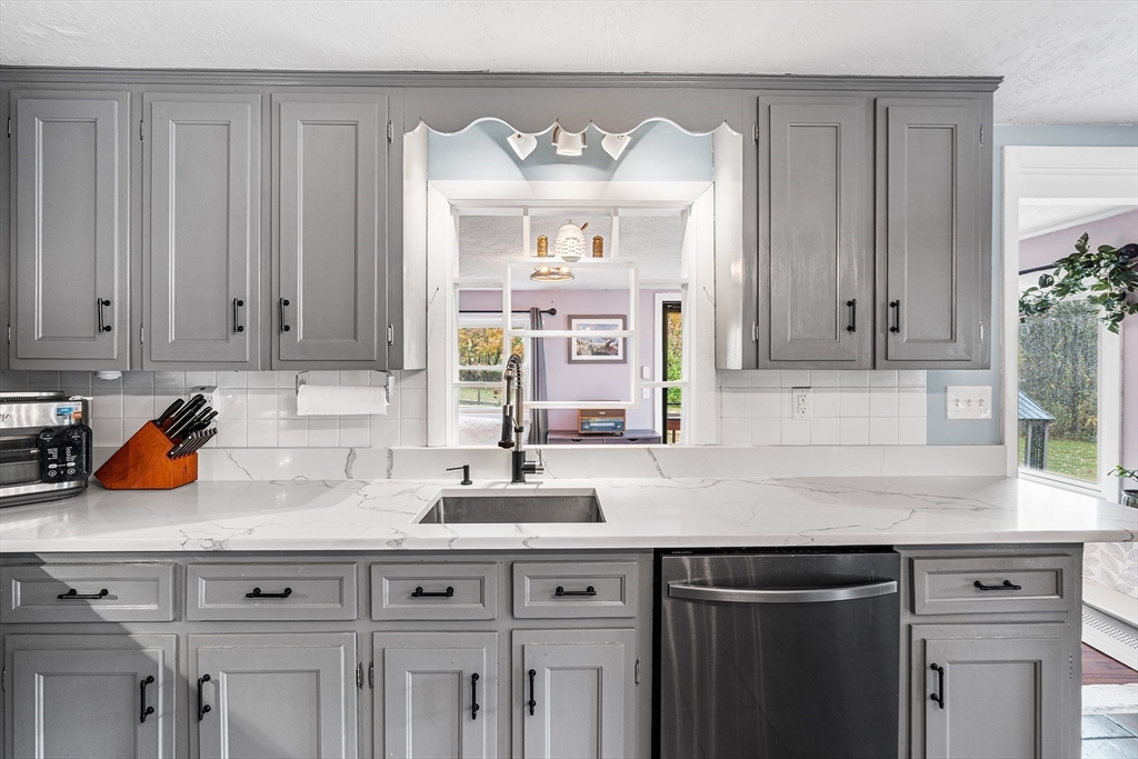 73 North Common Road Westminster, MA 01473 - Photo 6 of 41 a kitchen with stainless steel appliances granite countertop a sink dishwasher a stove and white cabinets