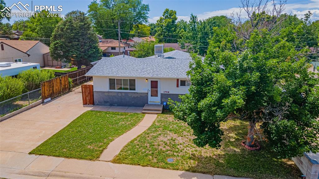 1732 Comanche Road Pueblo, CO 81001 - Photo 18 of 24 a view of house with a yard and potted plants
