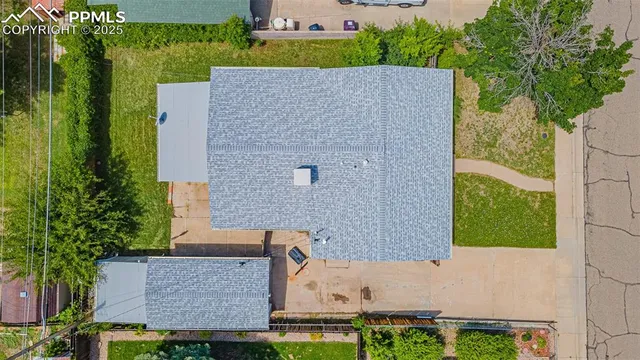 an aerial view of a house with a yard