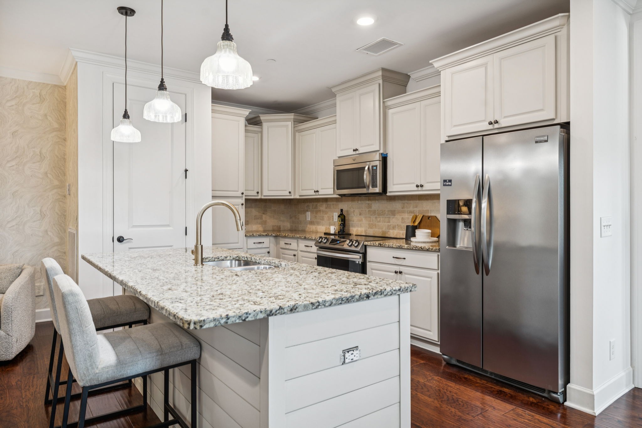 6000 Keats Street, Unit 202 Franklin, TN 37064 - Photo 17 of 47 a kitchen with kitchen island granite countertop a refrigerator a stove a sink and a refrigerator with wooden floor