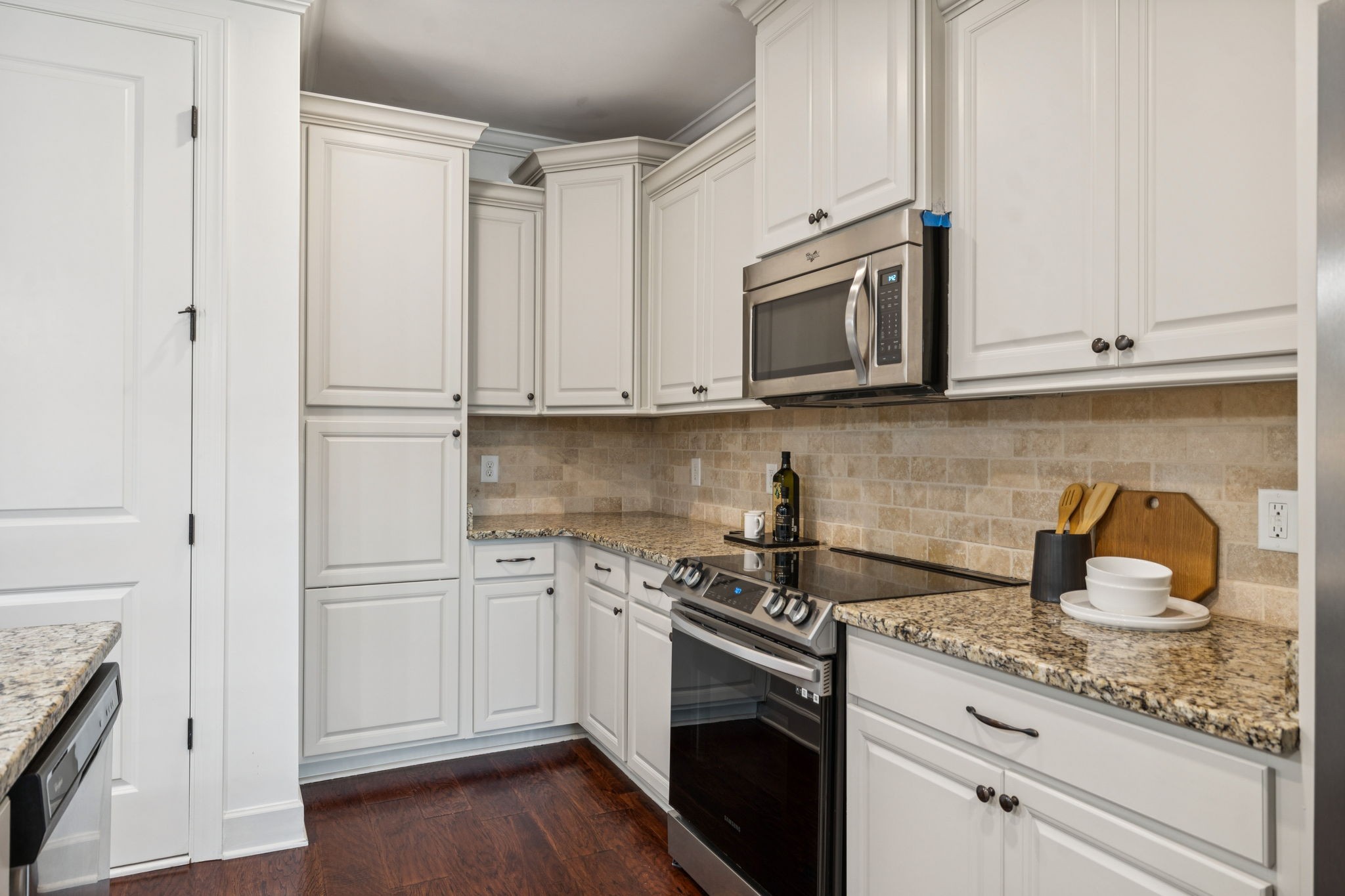 6000 Keats Street, Unit 202 Franklin, TN 37064 - Photo 21 of 47 a kitchen with granite countertop white cabinets and a stove top oven