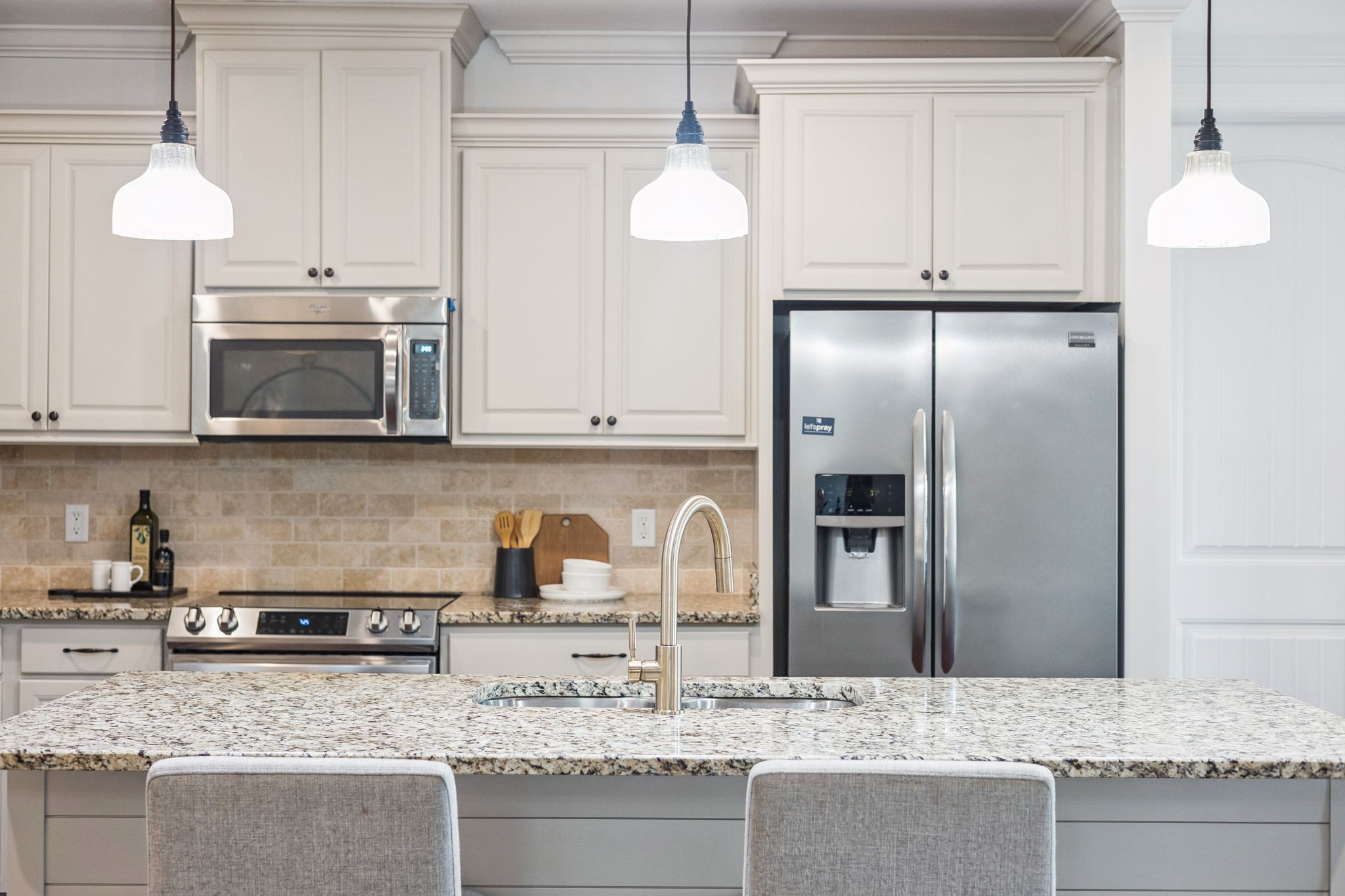 6000 Keats Street, Unit 202 Franklin, TN 37064 - Photo 25 of 47 a kitchen with stainless steel appliances granite countertop a sink a microwave a refrigerator and white cabinets