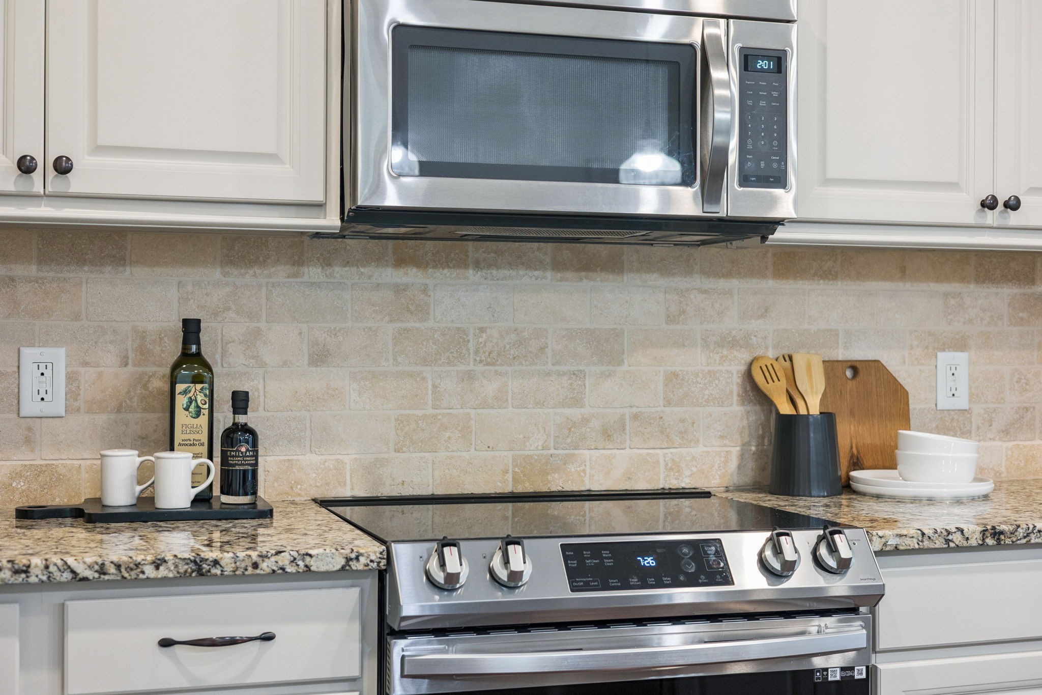 6000 Keats Street, Unit 202 Franklin, TN 37064 - Photo 26 of 47 a kitchen with granite countertop white cabinets and a stove