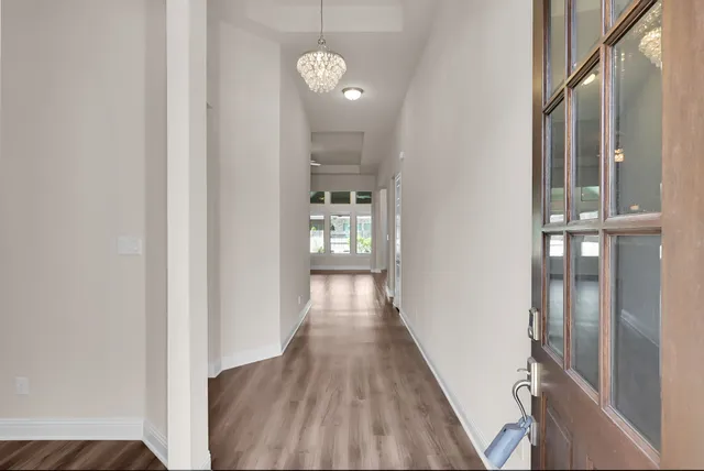 a view of hallway with wooden floor
