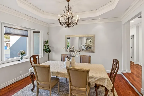 a dining room with furniture a chandelier and window