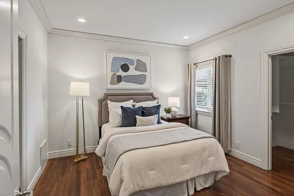 a bedroom with a large bed and a window