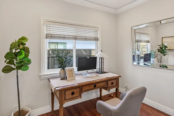 a bathroom with a granite countertop sink a toilet and a mirror