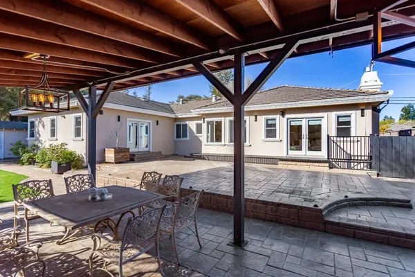 a view of a house with backyard and sitting area