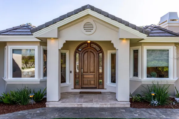 a front view of a house with garden